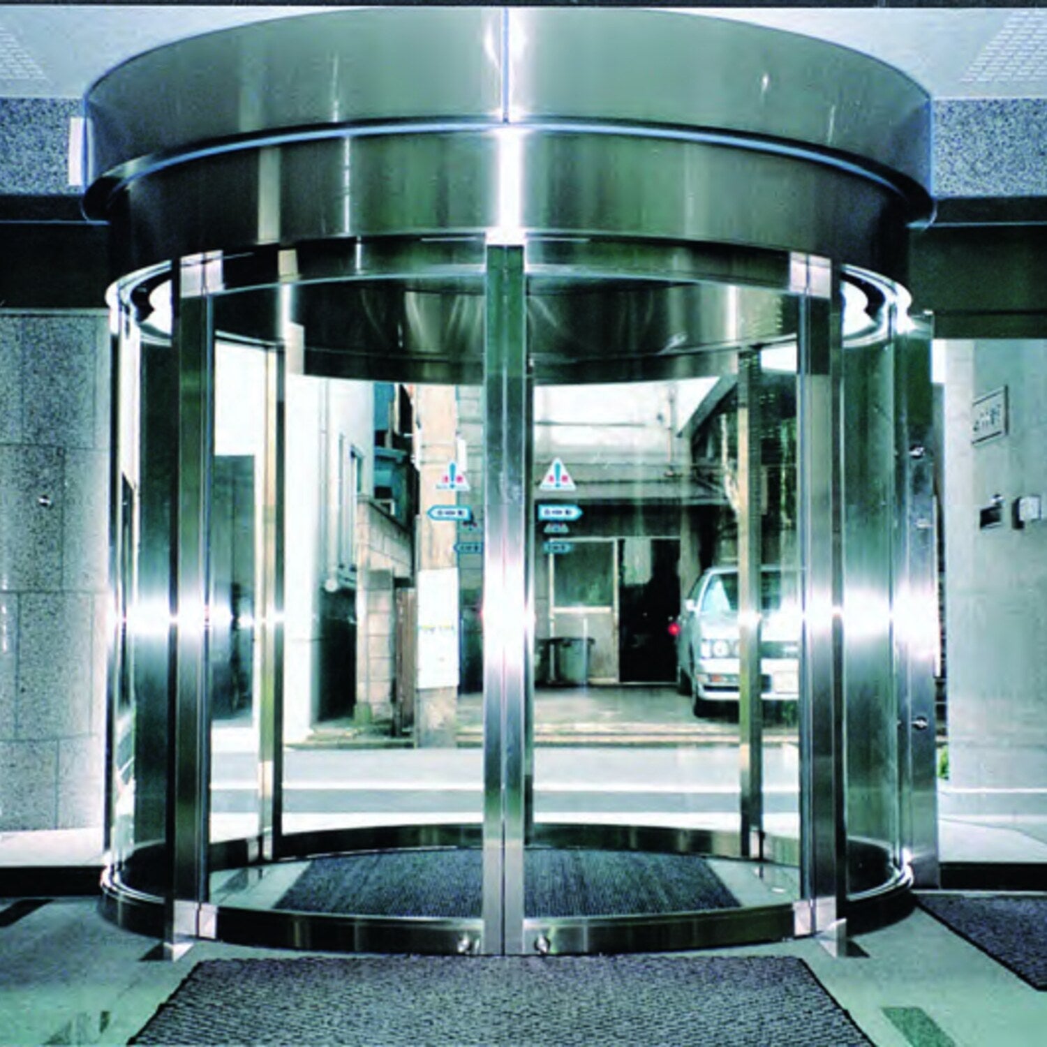 NABCO circular automatic door with curved glass leaves and stainless surround