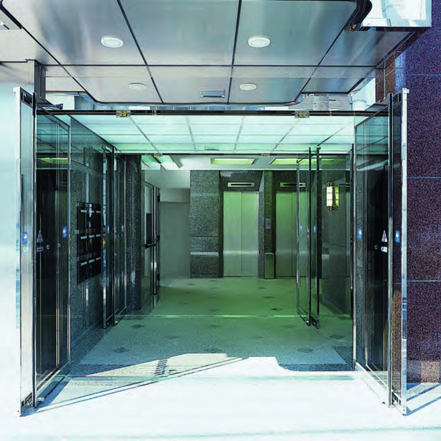 NABCO wide-open breakout automatic doors in a glazed corridor